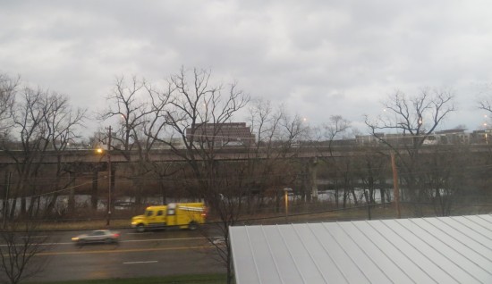 A gray hotel view of the nearest interstate and dead autumn trees.