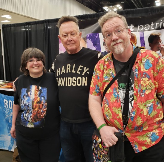 Us smiling and standing with the T-1000 himself, who's wearing a black Harley-Davidson shirt.