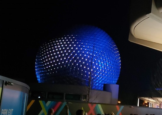 At night Spaceship Earth's giant golf ball turns indigo with white lights on each pinpoint.